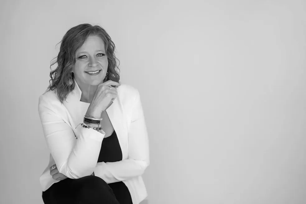 Leadership coach Cassie Trujillo seated and smiling during professional portrait for The Leaderful Life
