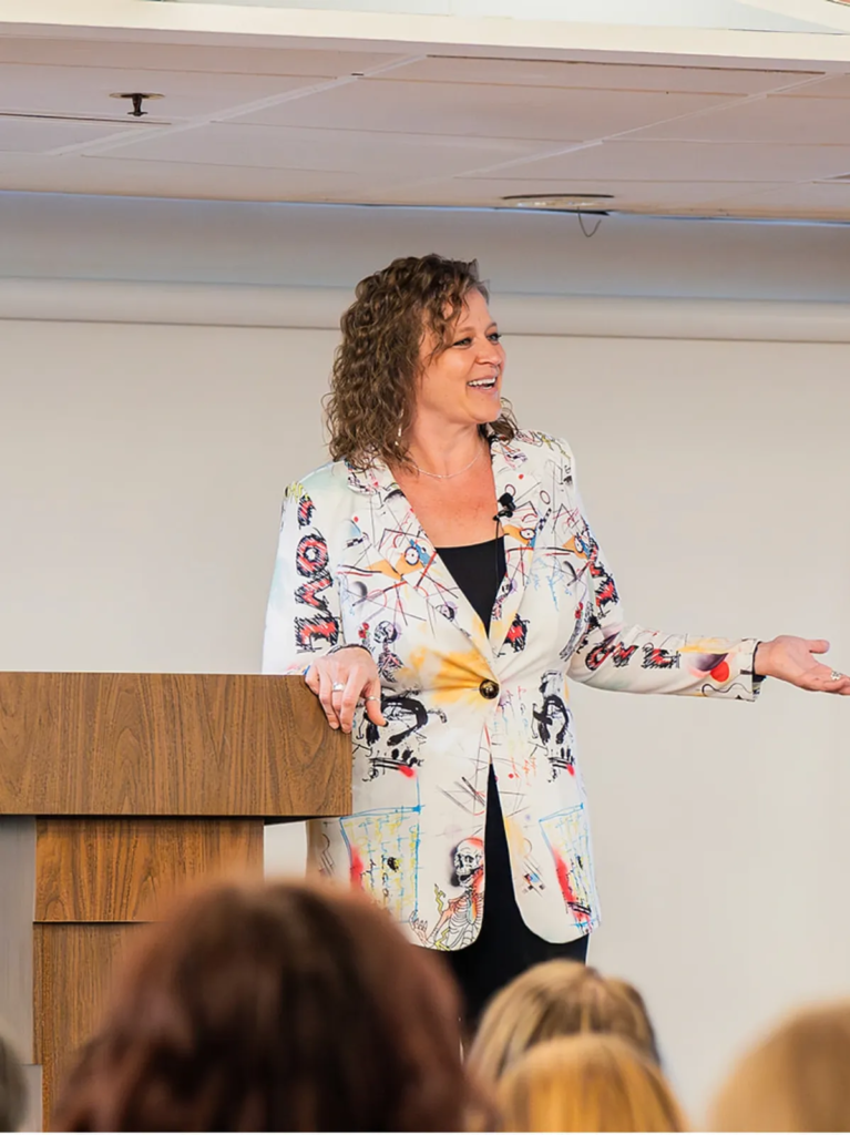 Cassie Trujillo speaking to an audience during a leadership development presentation in Southern Oregon